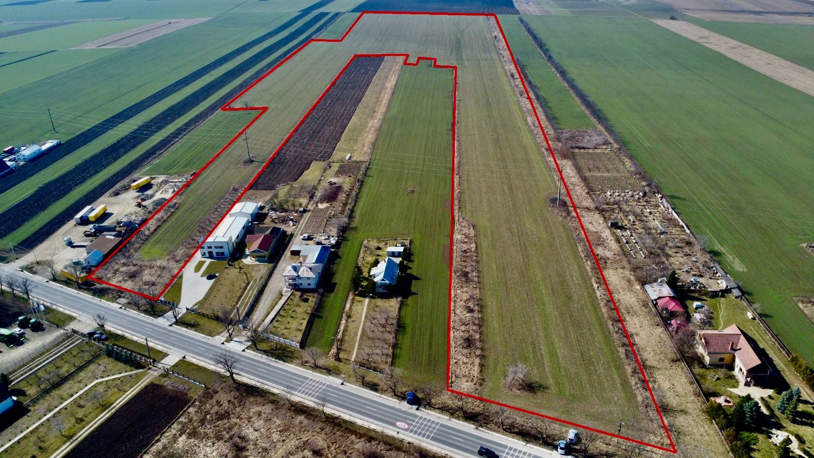 Aerial view from above European Road E58 with the property boundary outlined in red, extending back from the road frontage